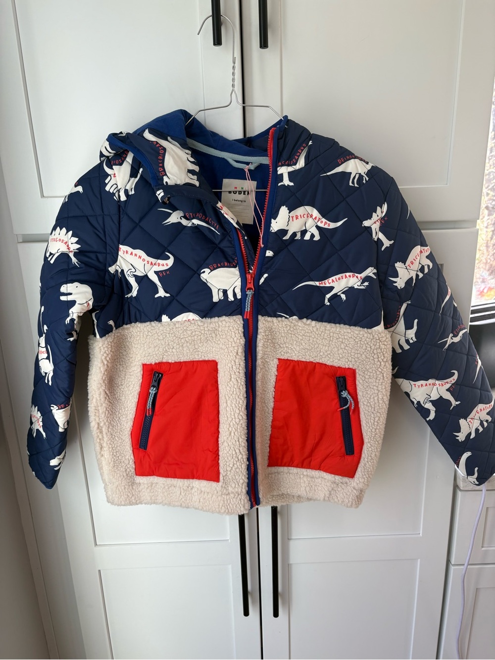 Mini Boden Navy Quilted Jacket with Cream Dino Print and Red Trim